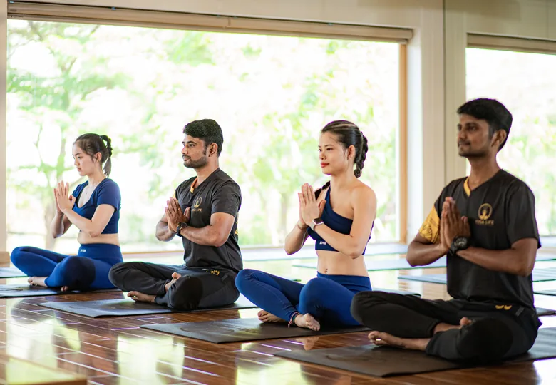 Yoga Life Premium teachers seated with students in a daylit studio