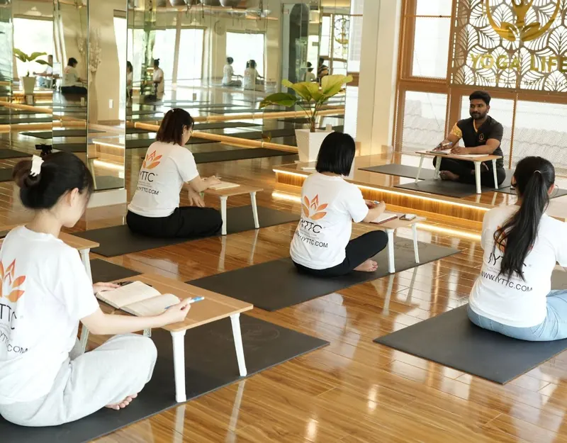 Teacher-training students practising with a teacher in the studio
